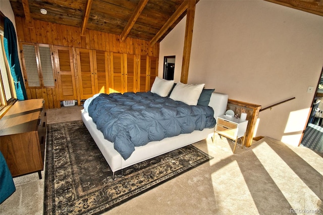 bedroom featuring carpet, lofted ceiling with beams, wood ceiling, and wooden walls