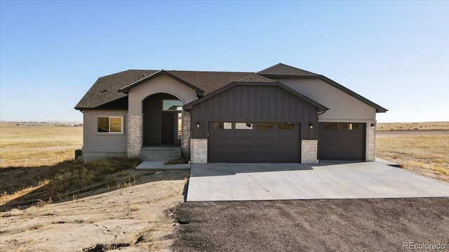 view of front facade with a rural view and a garage