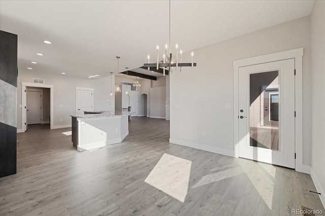 interior space with hardwood / wood-style flooring and a notable chandelier