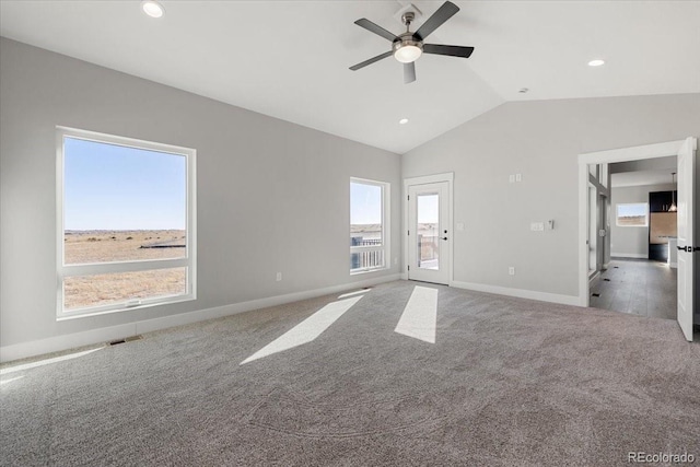 unfurnished living room featuring ceiling fan, light colored carpet, and vaulted ceiling