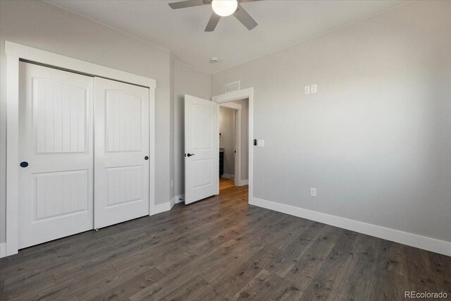 unfurnished bedroom with ceiling fan, dark hardwood / wood-style floors, and a closet