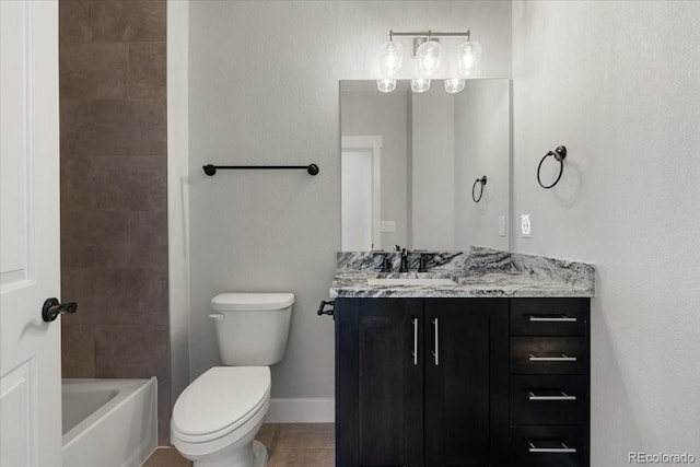 bathroom with tile patterned flooring, vanity, and toilet