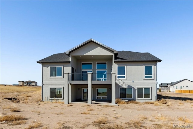 back of property featuring a balcony