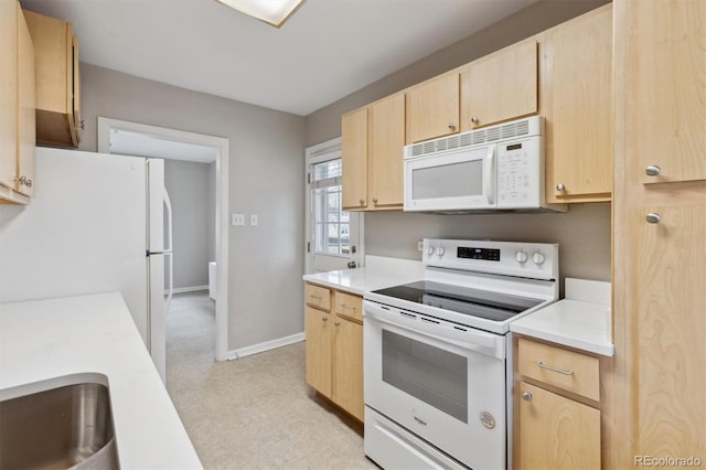 kitchen featuring white appliances, light floors, light brown cabinets, baseboards, and light countertops