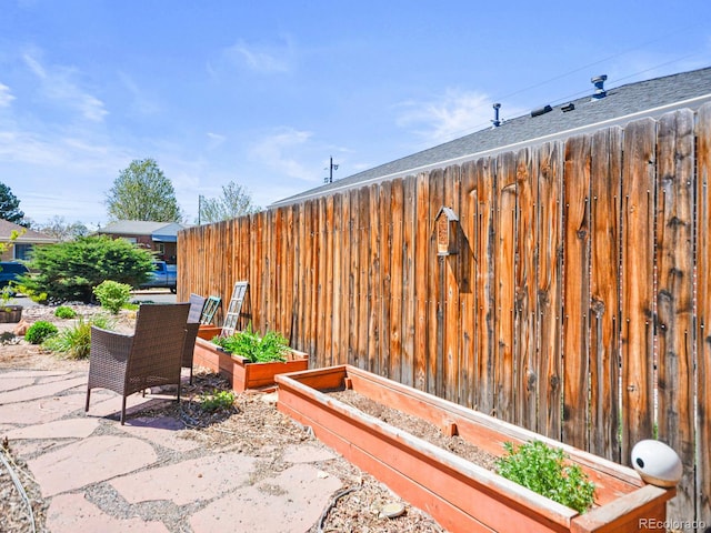 3450 N Harrison St, Denver, CO 80205 - view of patio with a garden and fence
