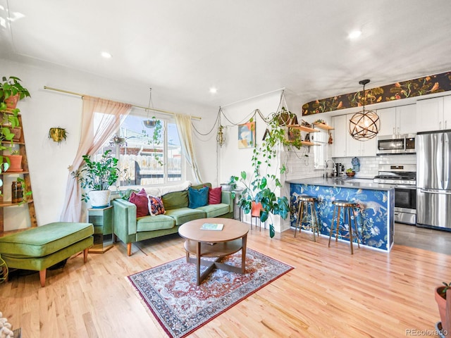 3450 N Harrison St, Denver, CO 80205 - living room featuring recessed lighting and wood finished floors