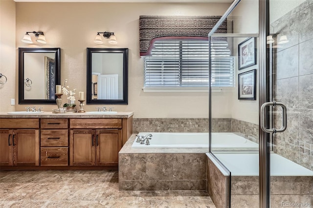 bathroom with a bath, double vanity, a sink, and tiled shower