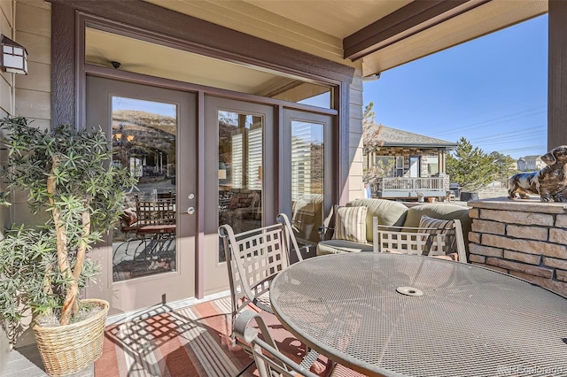 view of patio with outdoor dining space and a balcony