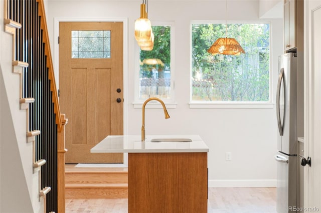 1048 Knox Ct, Denver, CO 80204 - entrance foyer featuring healthy amount of natural light, stairway, and baseboards