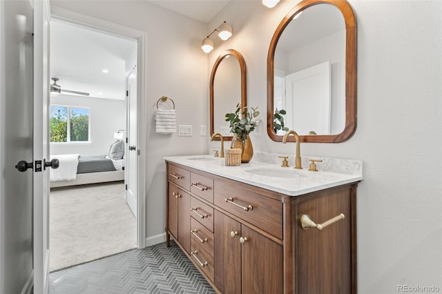 1048 Knox Ct, Denver, CO 80204 - ensuite bathroom with double vanity and baseboards