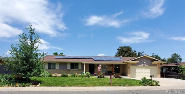 11835 W 37th Pl, Wheat Ridge, CO 80033 - ranch-style home with an attached garage, driveway, a front yard, covered porch, and solar panels