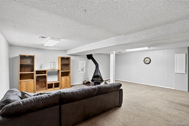 11835 W 37th Pl, Wheat Ridge, CO 80033 - living area featuring a wood stove, carpet floors, and a textured ceiling