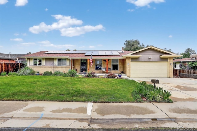 11835 W 37th Pl, Wheat Ridge, CO 80033 - single story home featuring a porch, brick siding, a garage, and roof mounted solar panels