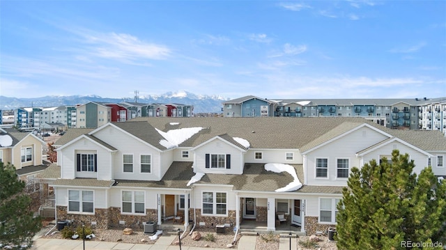 exterior space featuring a mountain view and central air condition unit