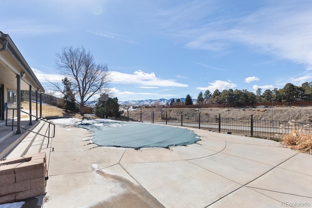 view of pool with a patio area, fence, a mountain view, and a fenced in pool