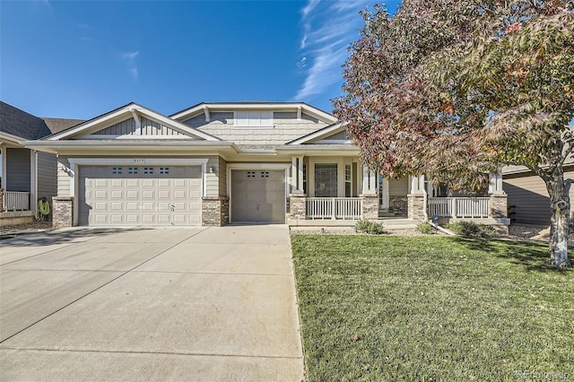 view of front of home featuring a garage, covered porch, and a front lawn