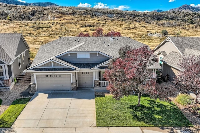 view of front facade with a mountain view and a front yard