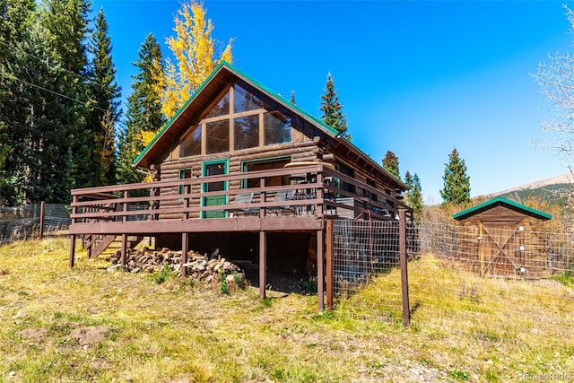 rear view of property featuring a wooden deck