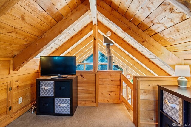 bonus room featuring wood ceiling, wooden walls, lofted ceiling with beams, and carpet floors