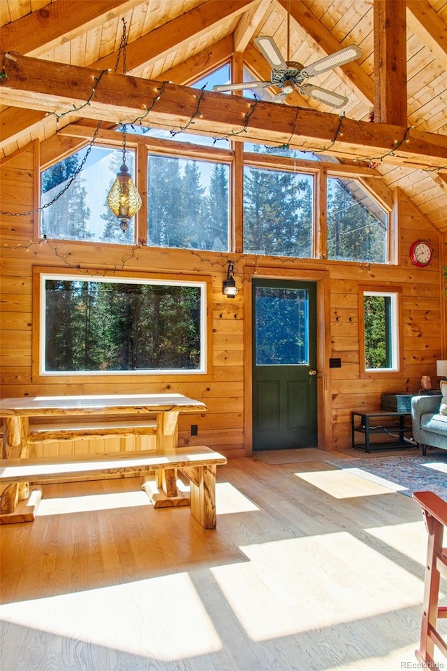 sunroom / solarium featuring vaulted ceiling with beams and wood ceiling