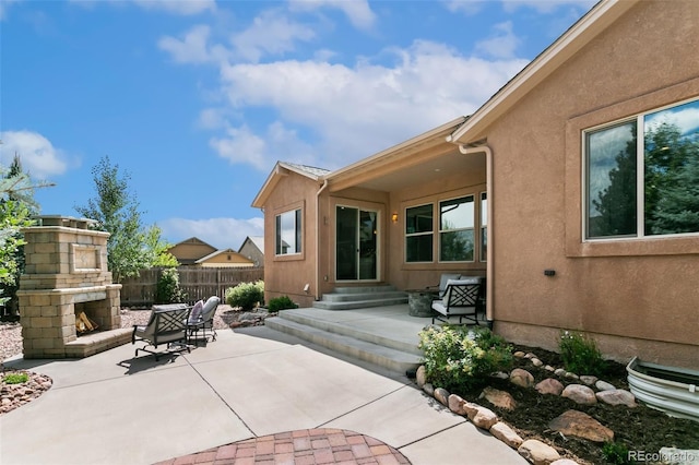 view of patio featuring an outdoor stone fireplace