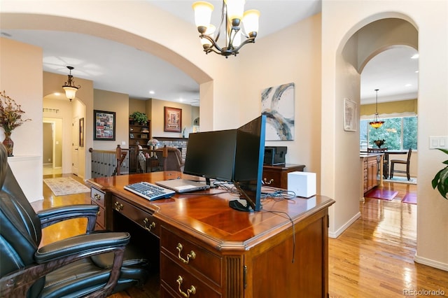 home office featuring a chandelier and light wood-type flooring