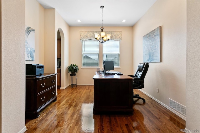 home office featuring a chandelier and hardwood / wood-style floors