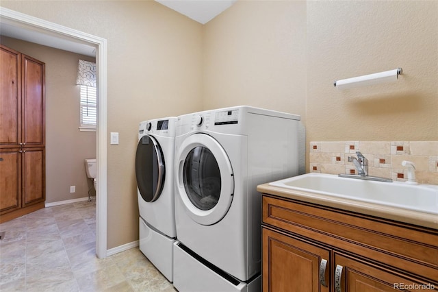 laundry area with cabinets, sink, and independent washer and dryer