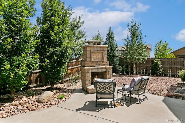 view of patio featuring an outdoor stone fireplace