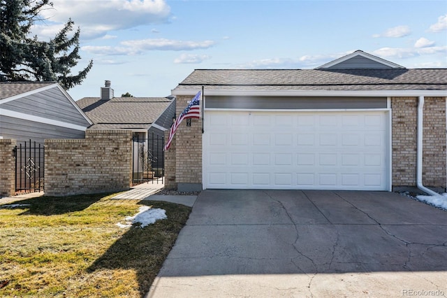 ranch-style house featuring a shingled roof, brick siding, fence, driveway, and a front yard