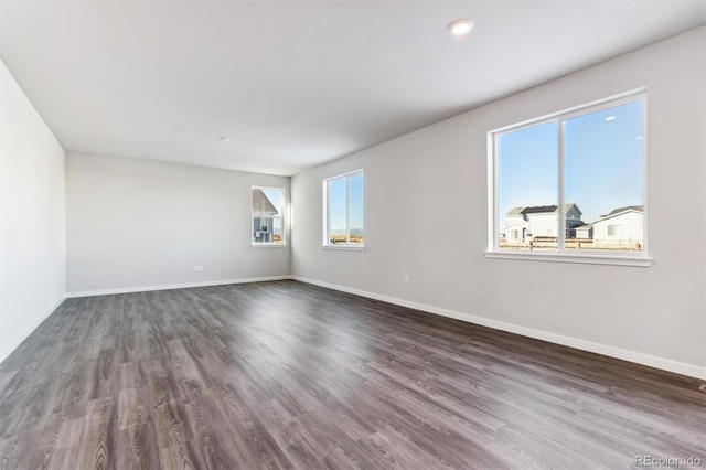 unfurnished room featuring dark wood finished floors and baseboards