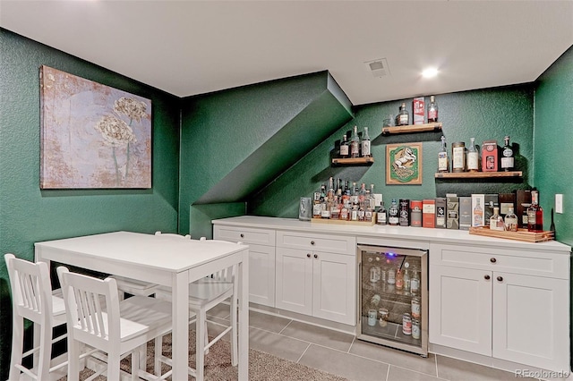 2337 S Franklin St, Denver, CO 80210 - indoor dry bar with a textured wall, wine cooler, and light tile patterned floors