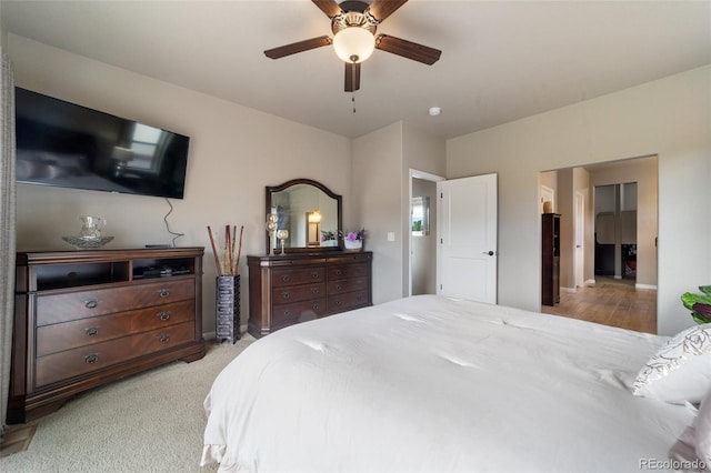 bedroom with ceiling fan and light carpet