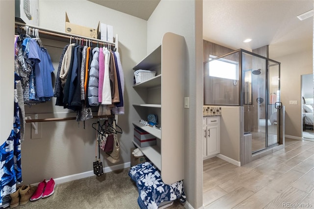 walk in closet featuring light hardwood / wood-style flooring