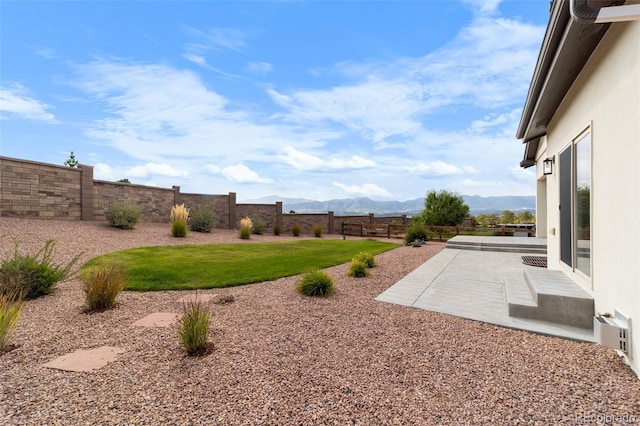 view of yard featuring a mountain view and a patio area