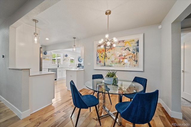 2865 S Cherry Way, Denver, CO 80222 - dining space with light wood-type flooring, baseboards, and a chandelier