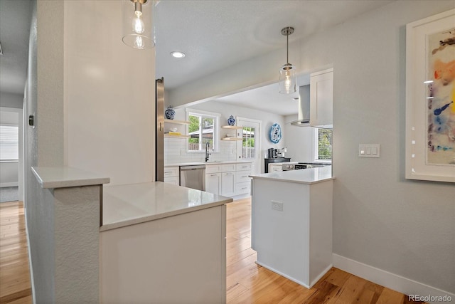 2865 S Cherry Way, Denver, CO 80222 - kitchen with stainless steel dishwasher, light wood-type flooring, baseboards, white cabinets, and open shelves