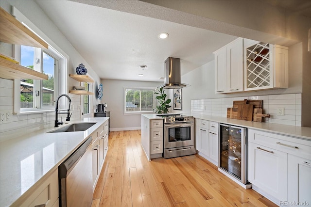 2865 S Cherry Way, Denver, CO 80222 - kitchen featuring beverage cooler, stainless steel appliances, a sink, island exhaust hood, and light wood-style floors