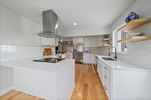 2865 S Cherry Way, Denver, CO 80222 - kitchen featuring island range hood, stainless steel appliances, a sink, open shelves, and recessed lighting