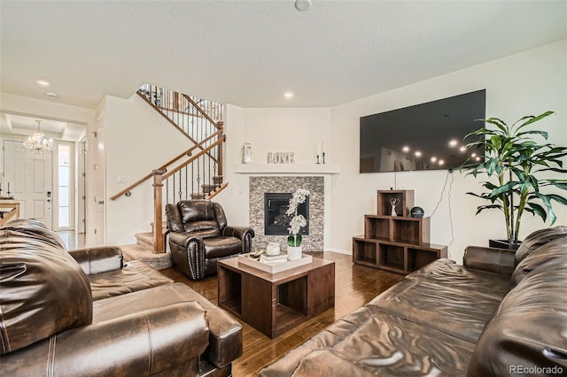 living area with stairs, a fireplace, dark wood-type flooring, and recessed lighting