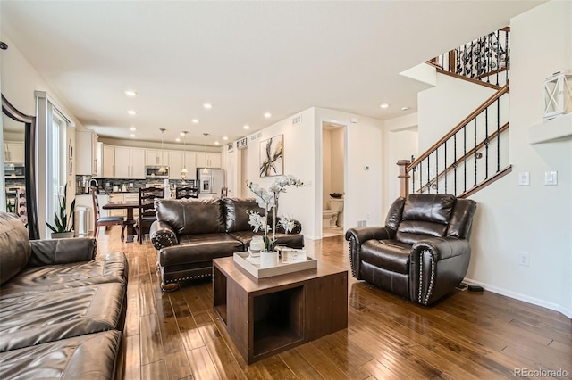 living room featuring visible vents, baseboards, dark wood finished floors, stairs, and recessed lighting