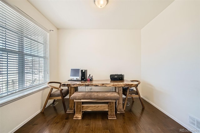 home office featuring wood finished floors, visible vents, and baseboards