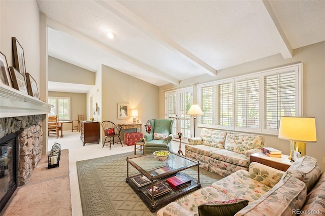 carpeted living room featuring a stone fireplace, a textured ceiling, and vaulted ceiling with beams