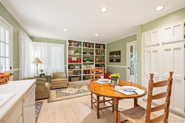 sitting room featuring ornamental molding and light hardwood / wood-style floors