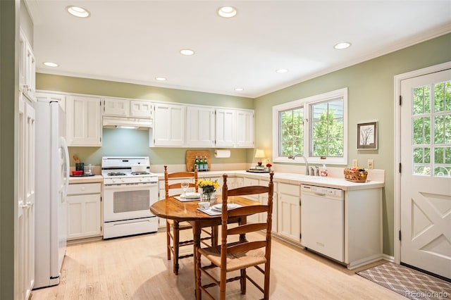 kitchen with sink, white cabinets, and white appliances