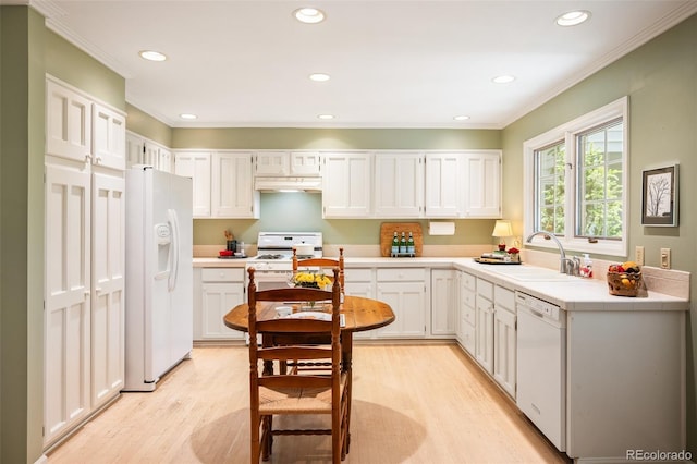 kitchen with sink, white appliances, light hardwood / wood-style flooring, and white cabinets