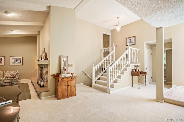 interior space featuring a fireplace, a textured ceiling, and carpet