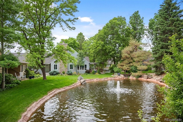 exterior space featuring a water view and a lawn