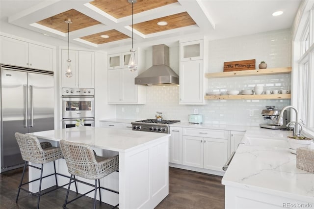 700 Apple Ridge Rd, Lyons, CO 80540 - kitchen featuring appliances with stainless steel finishes, wall chimney exhaust hood, a sink, a center island, and open shelves