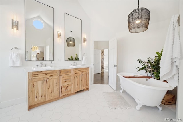 700 Apple Ridge Rd, Lyons, CO 80540 - full bathroom featuring high vaulted ceiling, a freestanding tub, double vanity, and baseboards